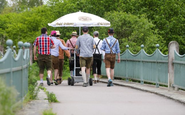 A group of men hike and enjoy a drink on Father's Day in Germany in 2023.