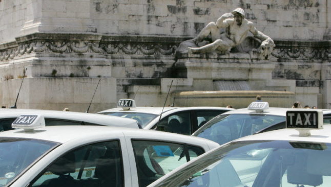 Taxis stationed in Rome's central Piazza Venezia square
