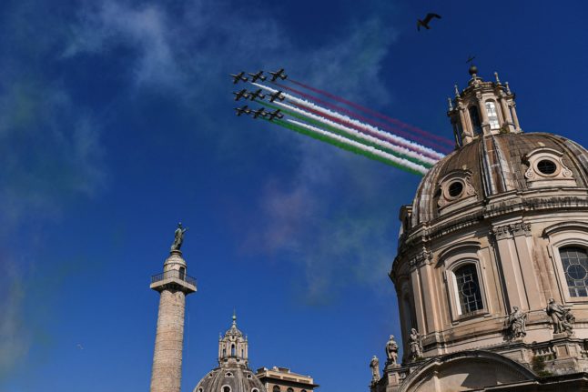 Italian Air Force unit Frecce Tricolori (Tricolour Arrows) leave trails of green, white and red smoke over Piazza Venezia in Rome
