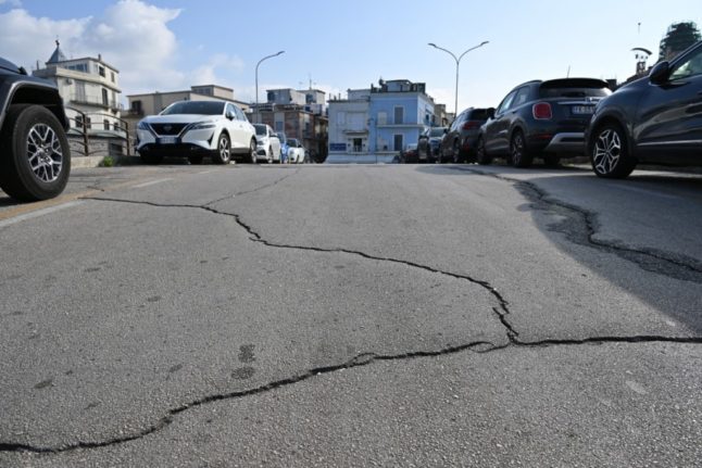 File photo of a road in the Campi Flegrei region, west of Naples, showing cracks following seismic tremors