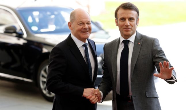 German Chancellor Olaf Scholz (L) shakes hands with French President Emmanuel Macron at the Chancellery in Berlin on March 15, 2024.