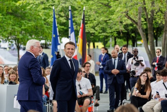 German President Frank-Walter Steinmeier L) and French President Emmanuel Macron attend a debate as part of the Festival of Democracy on May 26, 2024 in Berlin. The French president is on a three-day state visit to Germany.