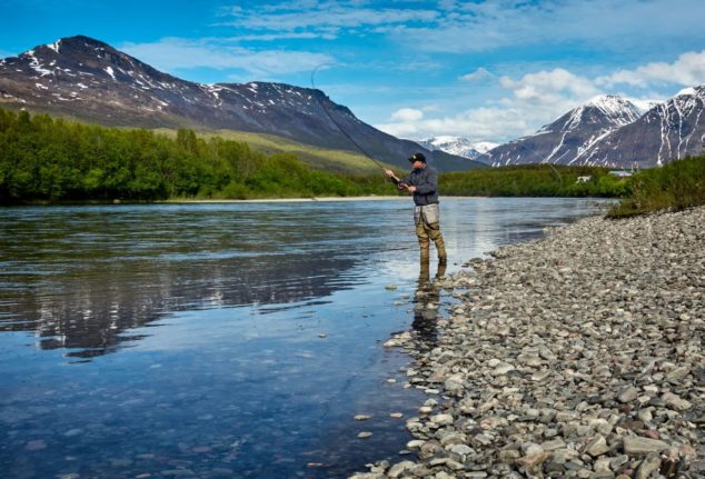 Pictured is a person fly fishing in Norway.
