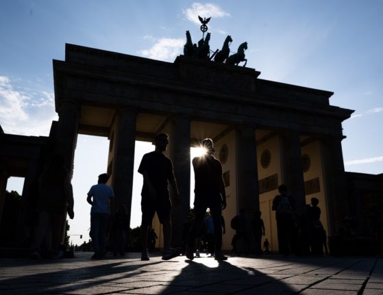 People walk through the Brandenburg Gate in Berlin
