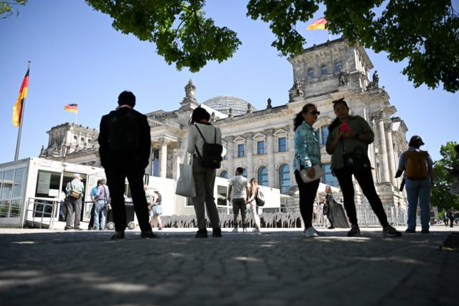 Visitors stand around outside the Reichstag in Berlin.
