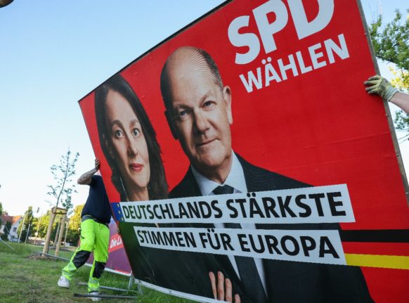 Employees dismantle an election poster in Halle for the SPD with a photo of Chancellor Scholz and the leading candidate Katarina Barley after the European elections