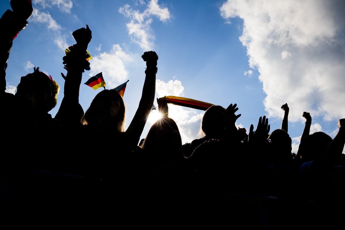 People celebrate the German national team at the Euros with German flags in Berlin. Germany has relaxed its citizenship laws.