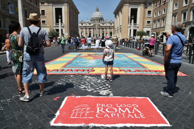 Frescoes painted on the pavement of Rome's Via della Conciliazione mark the feast day of Saints Peter and Paul