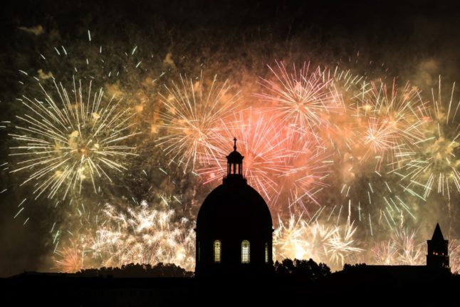 Fireworks exploding over the Dome de La Grave in Toulouse, south-western France
