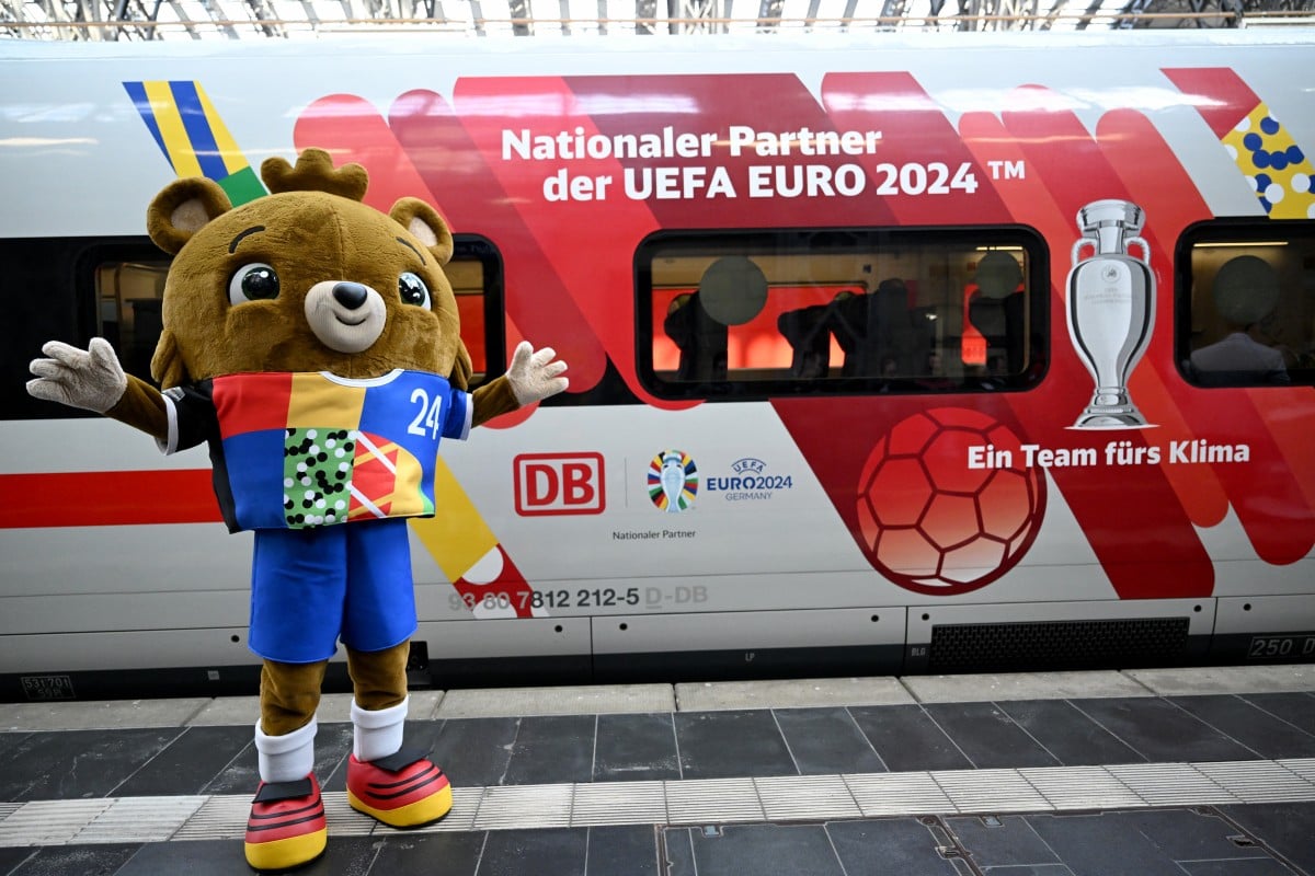 Albaert, mascot of the UEFA Euro 2024 European Football Championship, poses next to an ICE high speed train named "Fan-Hauptstadt Hamburg" in April 2024.