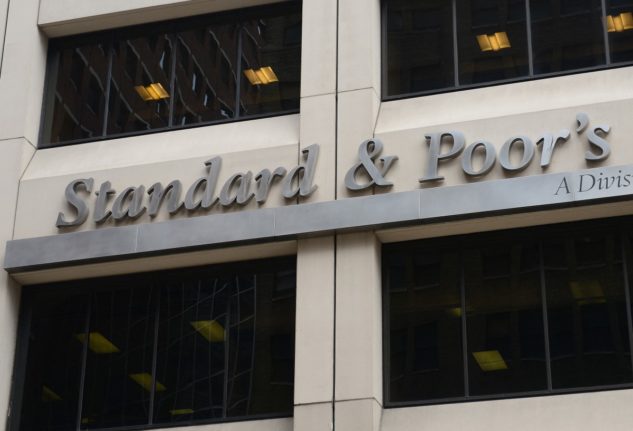 A sign for Standard & Poor's rating agency stands in front of the company headquarters in New York.