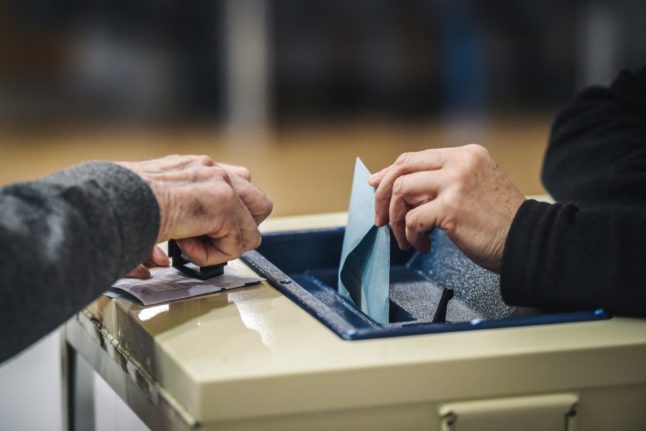 A person casts a ballot to vote during the 2019 European parliamentary elections.