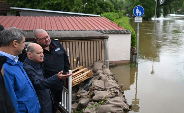 Bavaria's State Premier and leader of the conservative Christian Social Union (CSU) party Markus Soeder and German Chancellor Olaf Scholz visit flood-ravaged areas in Reichertshofen, southern Germany on June 3, 2024.