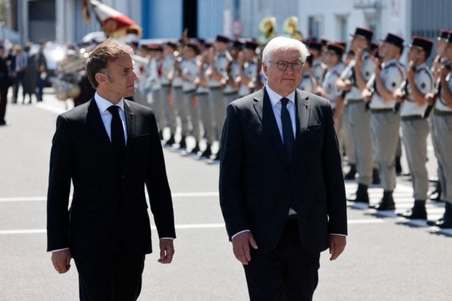 French President Emmanuel Macron (L) and German President Frank-Walter Steinmeier review a guard of honour at the Bellegarde airport in Limoges on June 10, 2024.