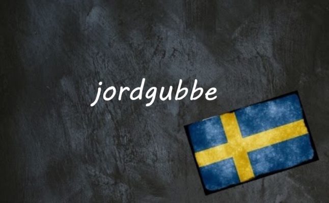 the word jordgubbe written on a blackboard next to the swedish flag
