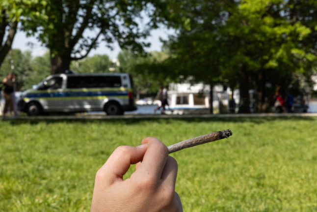 A person smokes a joint in Berlin.