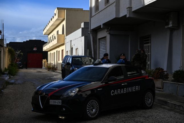 Italian police officers pictured outside one of the hideouts used by mafia boss Matteo Messina Denaro in Campobello di Mazara