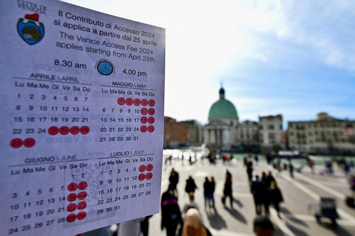 A calendar of Venice's entry fee scheme outside the city's Santa Lucia railway station