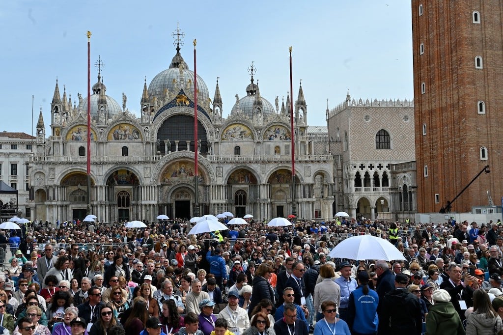 Crowds attend a mass presided over by Pope Francis at Venice's St. Marks square on April 28, 2024. 