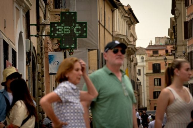 A pharmacy's sign indicates the temperature of 36 degrees Celsius near the Spanish Steps in Rome