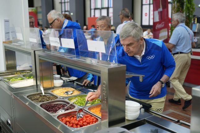International Olympic Committee President Thomas Bach at a salad bar at the Olympic Village