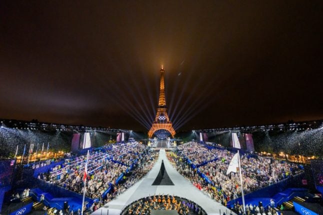 Overview of the Trocadero venue, with the Eiffel Tower looming in the background while the Olympic flag is being raised, during the opening ceremony of the Paris 2024 Olympic Games