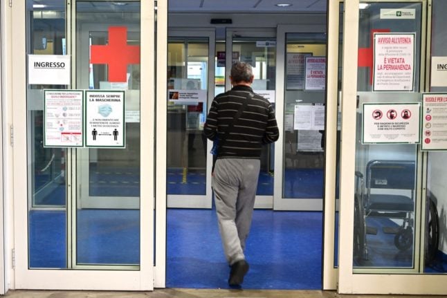 A man walks though the doors of Garbagnate hospital, near Milan