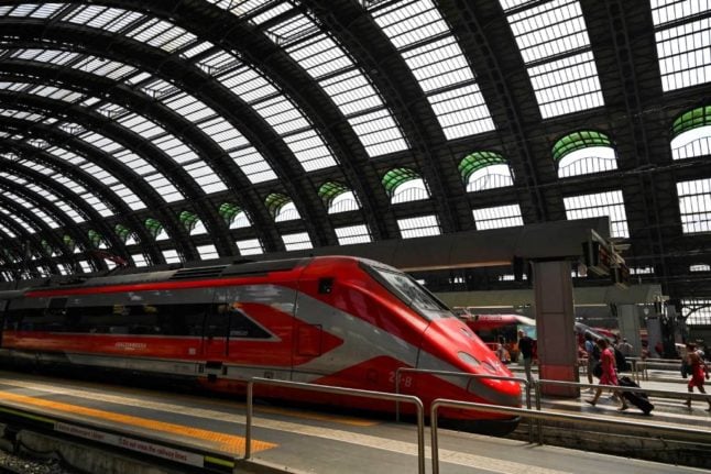 View of a Freccia Rossa high-speed train stationed at Milan's Stazione Centrale