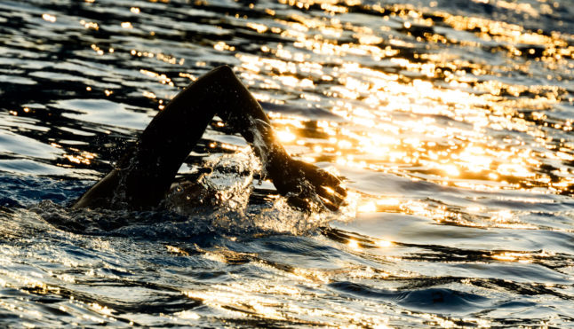 A person goes for an early morning swim in Hanover on July 30th.