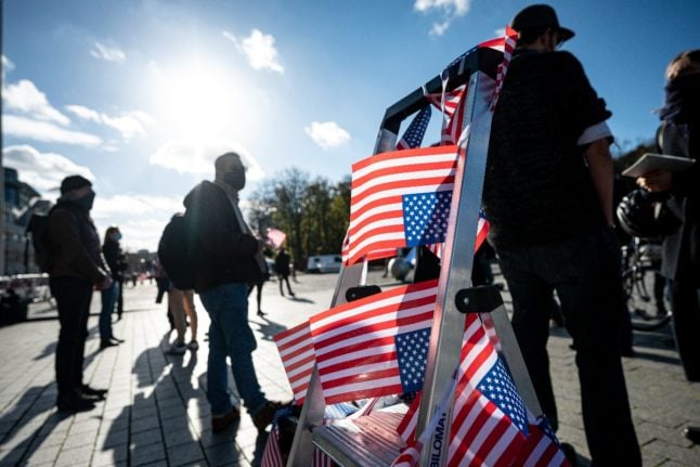 US flags near Brandenburg Gate in Berlin.