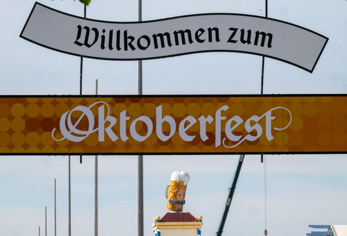 A sign reading "Welcome to Oktoberfest" hangs above the entrance to the Oktoberfest grounds on the Theresienwiese.