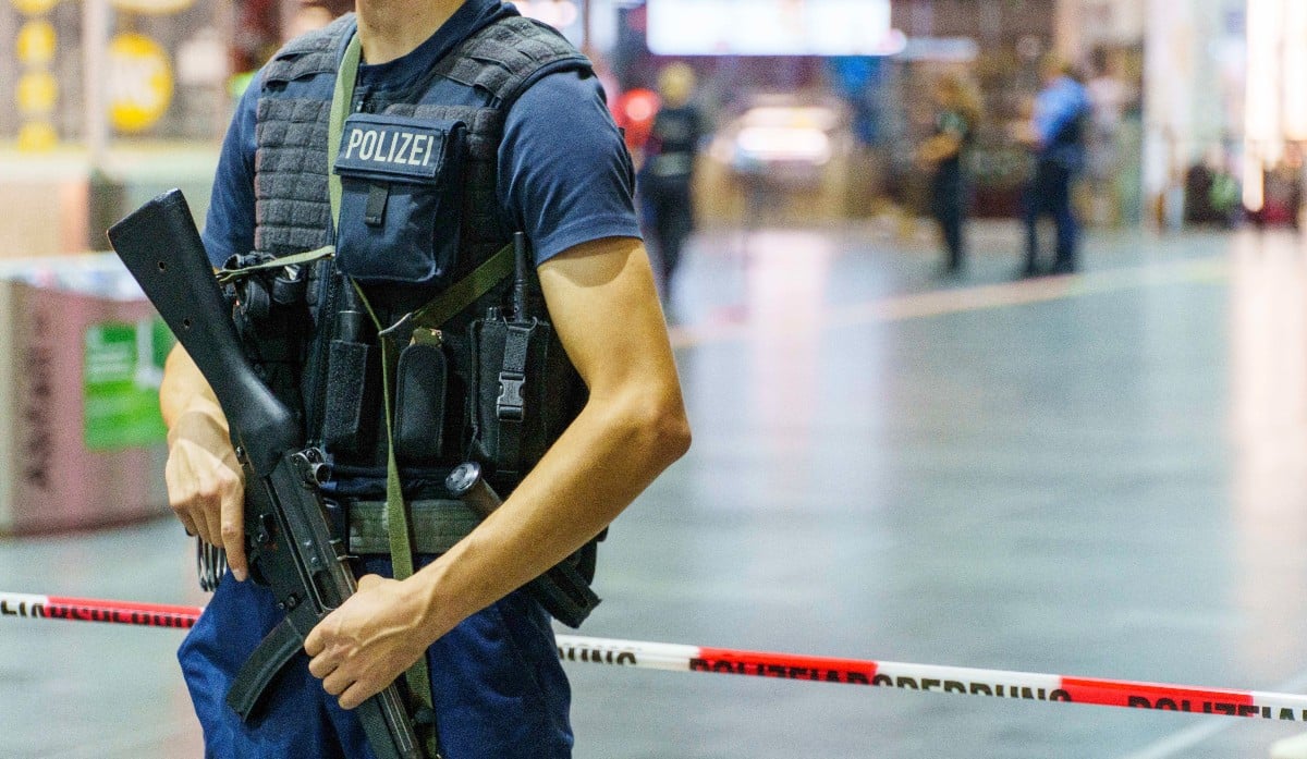 A police offer stands guard at Frankfurt main station after the shotting.