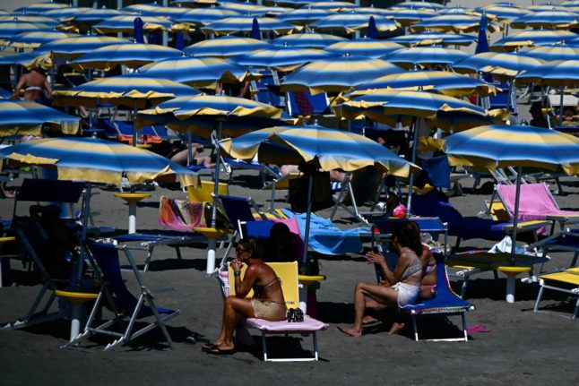 People enjoy the beach in Fiumicino, Italy