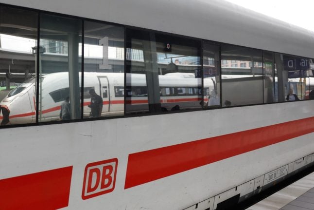 The first class carriage of a Deutsche Bahn ICE train is seen at a platform.