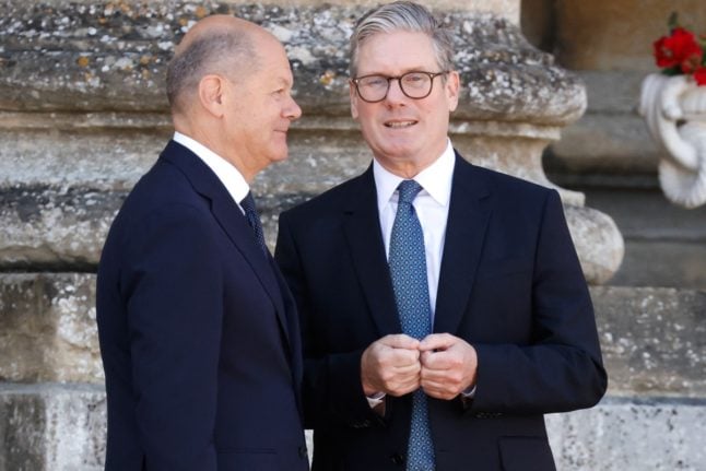 Britain's Prime Minister Keir Starmer greets Germany's Chancellor Olaf Scholz (L) prior to the Meeting of the European Political Community at the Blenheim Palace in Woodstock, near Oxford, on July 18, 2024.