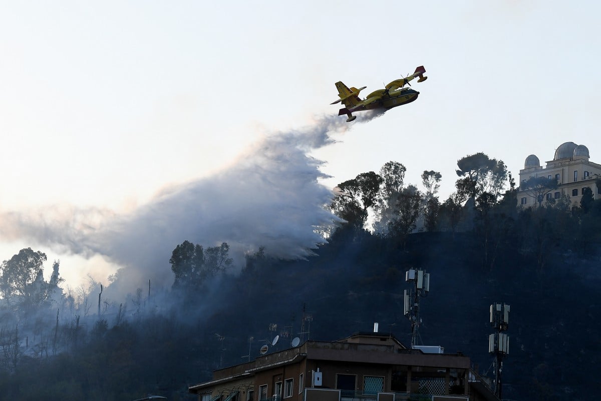 A Canadair releases water over a vast wildfire in Rome's Monte Mario area on July 31st 2024