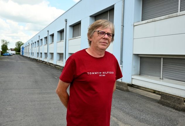 CFDT union member Bruno Bodson poses in front of the Walor factory in Vouziers, north eastern France