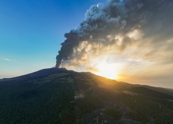 An aerial view shows a plume of ashes during an eruption of the Mount Etna volcano early on August 4, 2024 in Sicily.