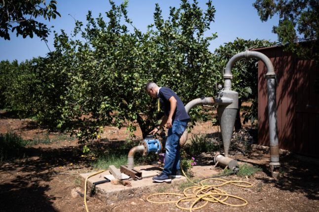 Italian farmer and member of Coldiretti farmers' association, Rosario Cognata, checks the water well in his lemon field where fruits suffer high temperatures, in Campobello di Mazara, south west of Sicily, on August 8, 2024. Drought hits agriculture badly in Sicily. Dams are nearly empty and obsolete irrigation system provoke anger among farmers.