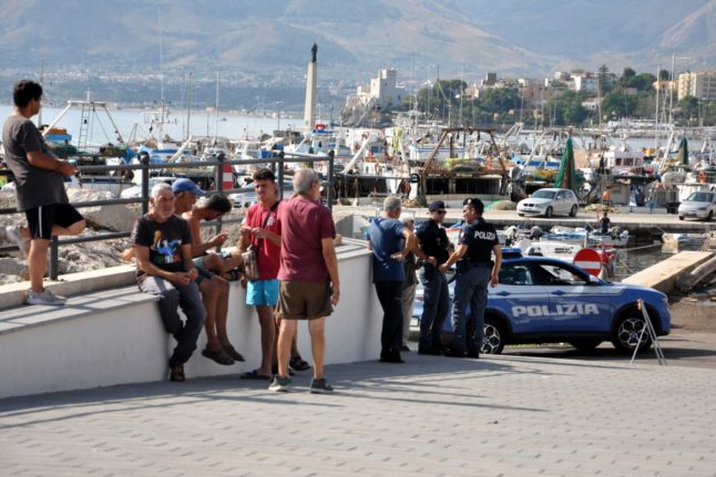 Italian police officers patrol the port of Porticello, near Palermo