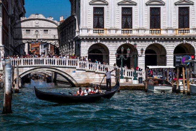 A gondola boat is pictured in front of Venice's famous Bridge of Sighs in 2022