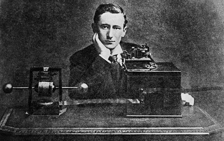 Italian inventor Guglielmo Marconi posing in front of his early radio apparatus.