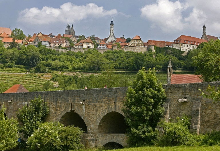 Pastel-coloured stone houses dating back to the middle Ages are seen above the old city fortifications of Rothenburg ob der Tauber in the Franconia region of Germany.