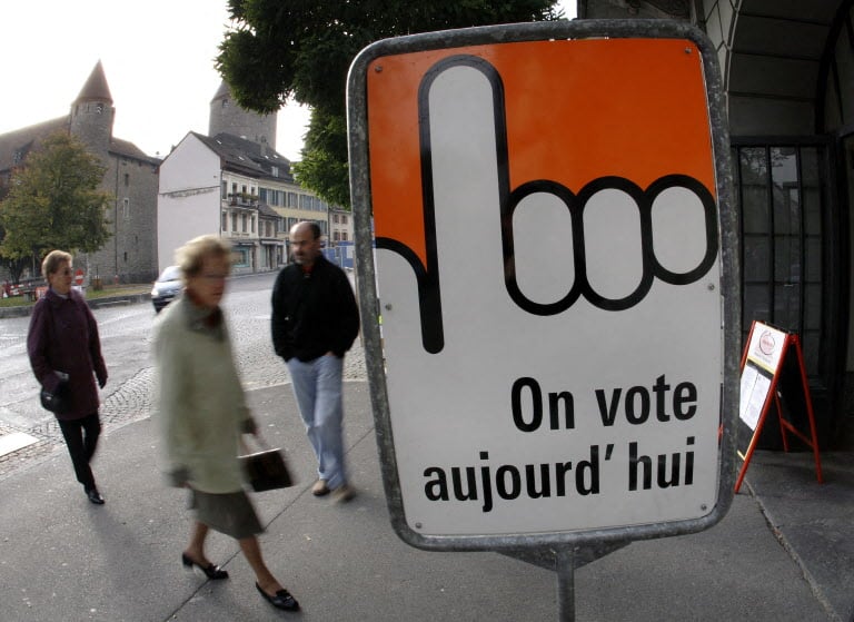 Women arrive at a polling station to casts their ballot during the Federal Parliament elections 21 October 2007 in Bulle.