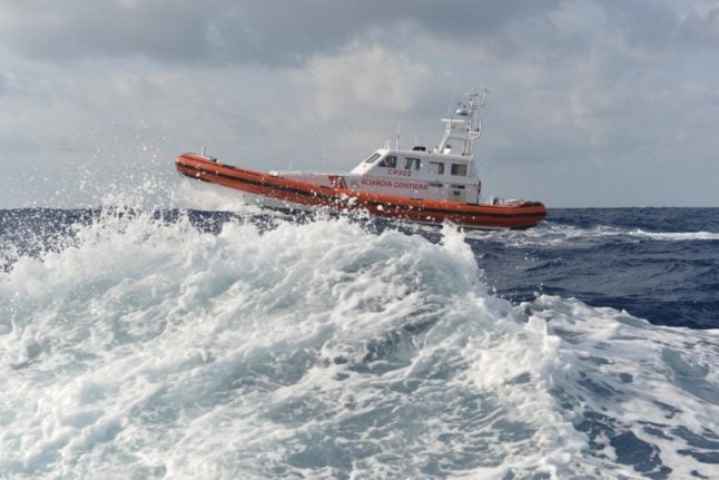 An Italian coast guard boat patrols the sea near Lampedusa harbour.