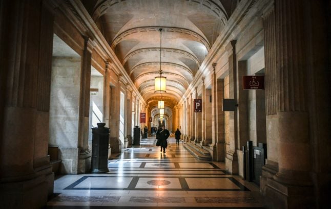 A lawyer walks at the Palais de Justice, Paris' main law court.