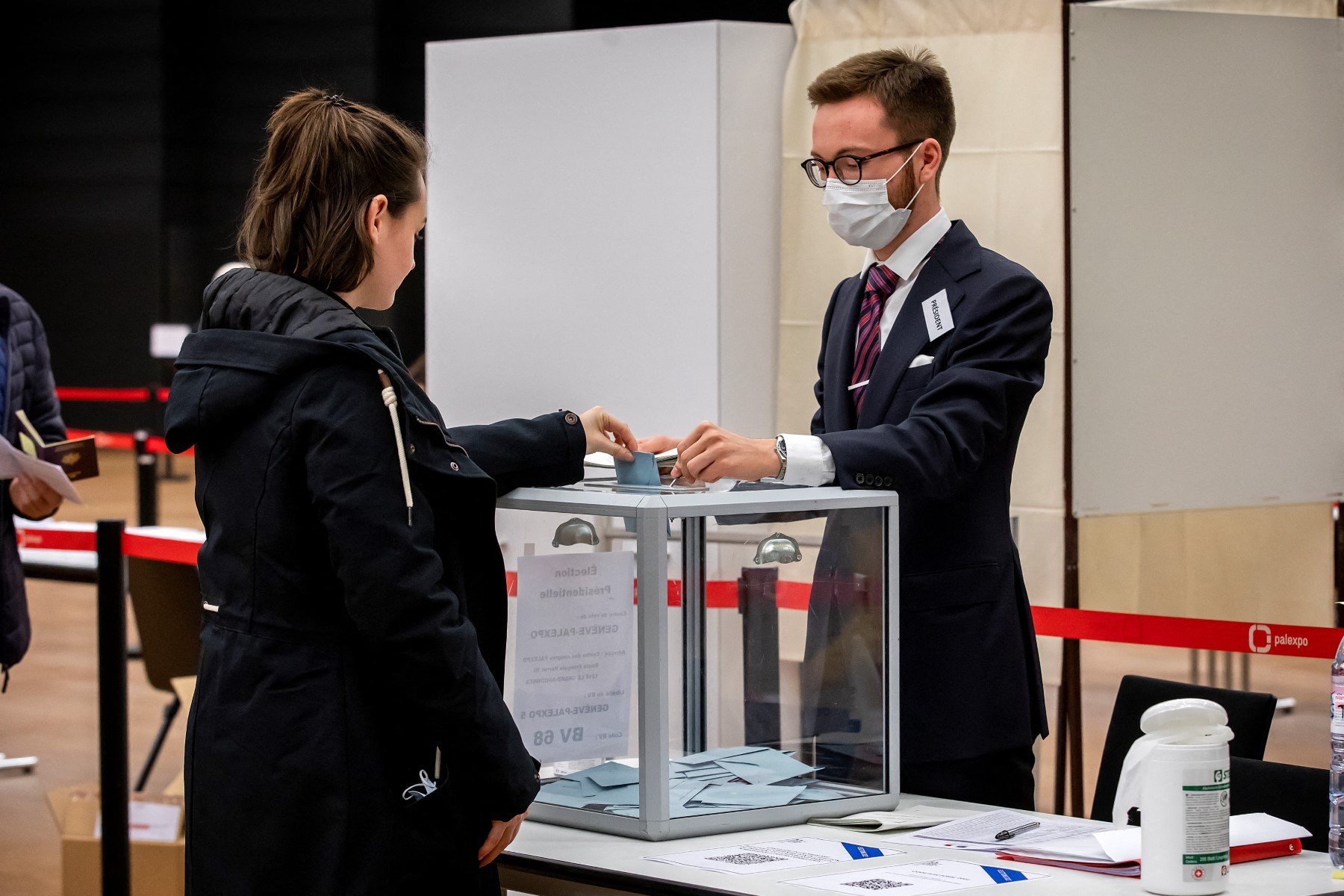 A woman casts her ballot during the first round of the French Presidential election, at Palexpo polling station for French citizens living in Switzerland, in Geneva, on April 10, 2022