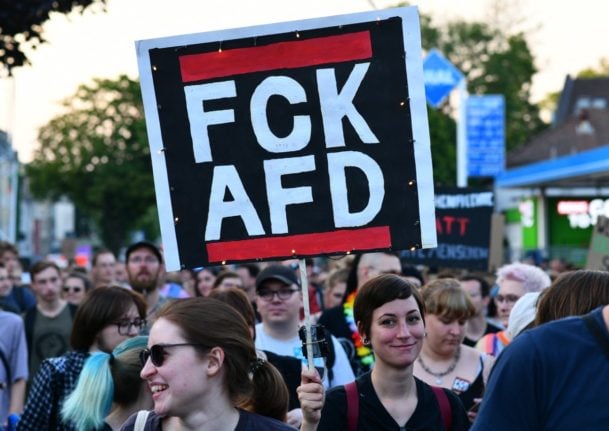 protestor with a FCk AFD sign