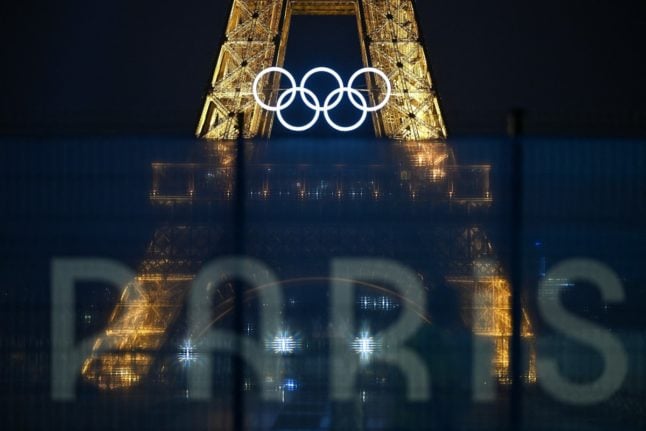 This photograph shows the Eiffel Tower bearing the Olympics rings, lit-up ahead of the Paris 2024 Olympic and Paralympic Games.