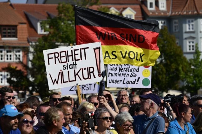 Supporters hold up the German national flag reading 